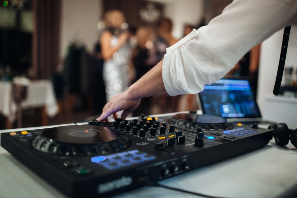 DJ manipulant sa console de mixage pendant une soirée festive